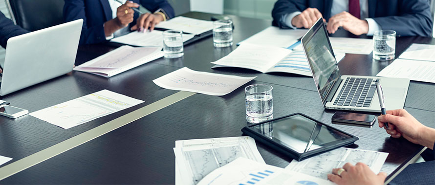 Business professionals working in board room